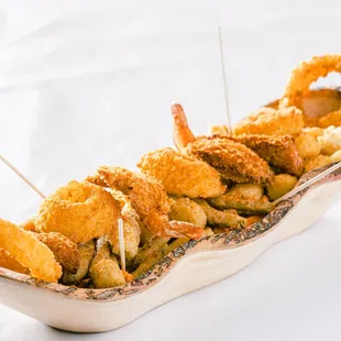 a dish of deep fried shrimp with toothpicks