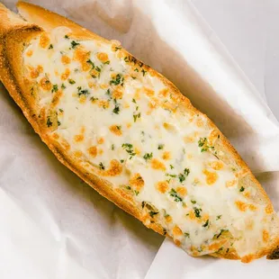 a piece of bread with cheese and herbs