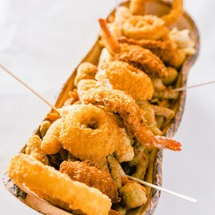 fried shrimp skewers in a paper boat