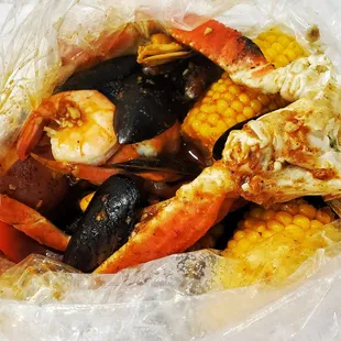 Combo with black mussels, crab legs, shrimp, corn, potatoes