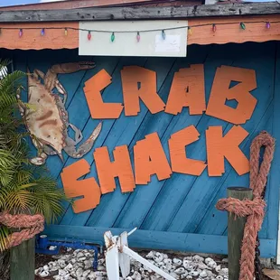 a crab shack with a sign that says crab shack