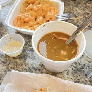 A piece of the fried chicken, gumbo, fried green tomatoes in the back.