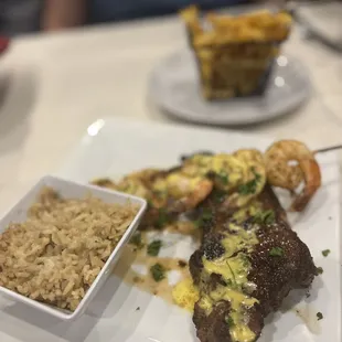 NY Strip &amp; Shrimp with dirty rice &amp; fries.