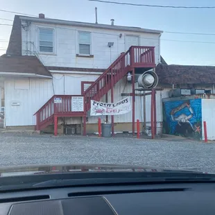 a red staircase leading up to a white building