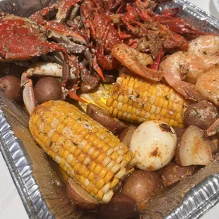 a tray of seafood and potatoes