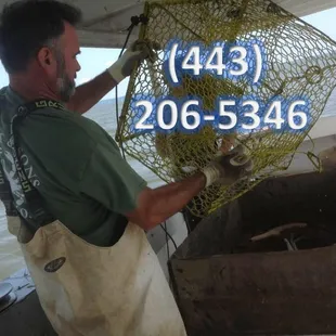 a man holding a crab net