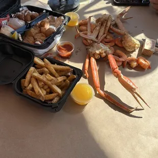 crab legs, fries, and orange juice