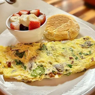 Omelette. Side fruit. Side biscuit.