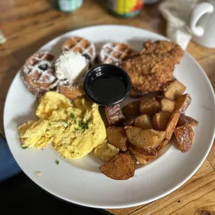 Waffles, fried chicken, scrambled eggs, potatoes