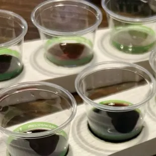 5 wine flights ($9 each) served in small plastic med-type cups.