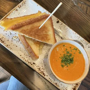 a grilled cheese sandwich and a bowl of soup