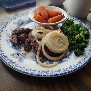 Burnt hamburger steak and hard broccoli.