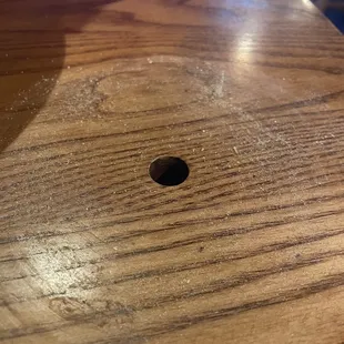 This is the dirt and grime under the oil lamp. The hole provides a place for the peg to sit so the lamp doesn&apos;t fall off.