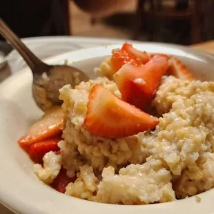 a bowl of oatmeal with strawberries