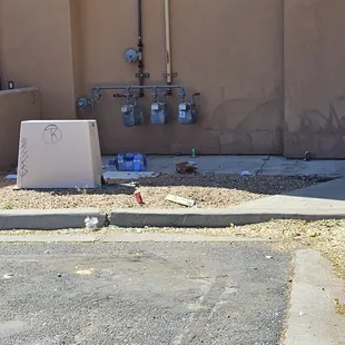  broken refrigerator in front of a building