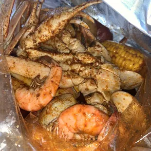 Headless shrimp, snow crab, corn, clams. Medium heat and their crackin sauce