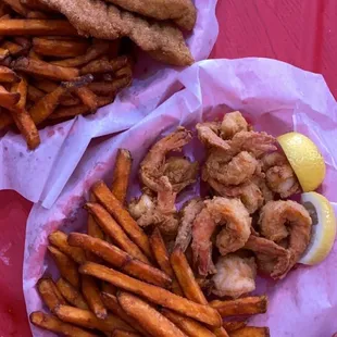 wo baskets of fries and a sandwich
