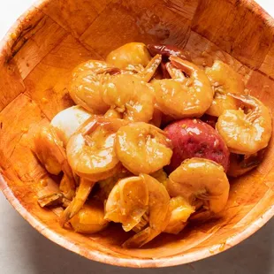 a wooden bowl filled with crackin crawfish