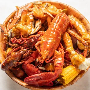 a bowl full of crackin crawfish and corn