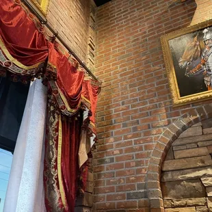 a brick fireplace and a painting