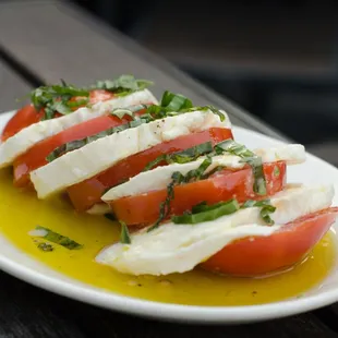 a plate of tomatoes and mozzarella