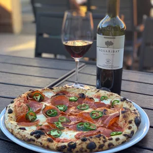 Honey bee pizza and bottle of Malbec on the patio. Don&apos;t mind if I do!