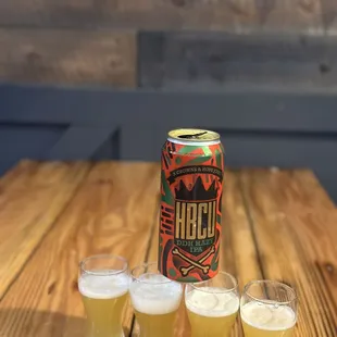 a can of craft and four glasses of craft beer