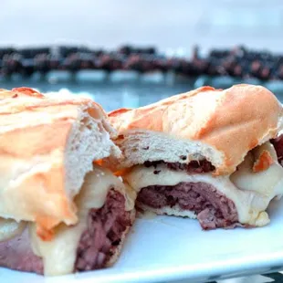 Drunken Cow - Hot roast beef topped with melted Swiss cheese on a baguette with a Left Hand Milk Stout au jus.