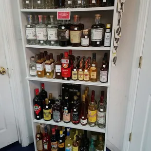 a shelf full of liquor