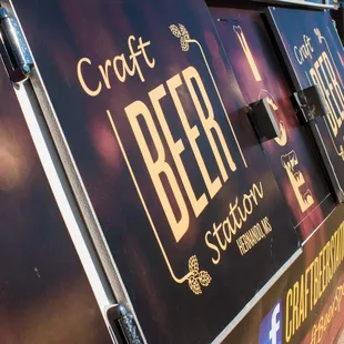 a craft beer truck parked on the side of the road
