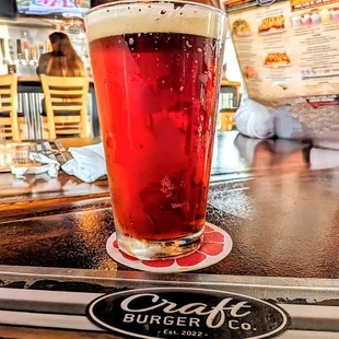a pint of beer on a bar