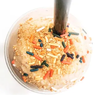 a frosted cake with sprinkles