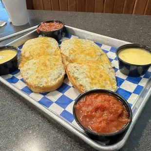 a tray of bread and condiments