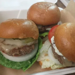 two burgers in a styrofoam container