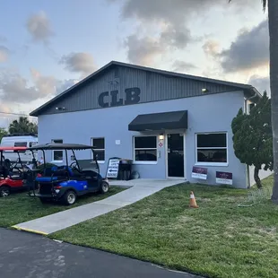several golf carts parked in front of a building