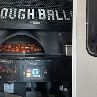 Fire roasting their tomatoes in the morning to prepare their sauce for the day...