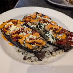 Oven roasted eggplant, chickpea, tomatoes, wild rice and mushrooms with romesco sauce.