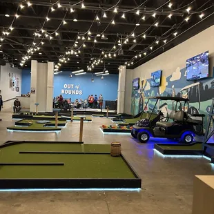 a golf course with golf carts and people
