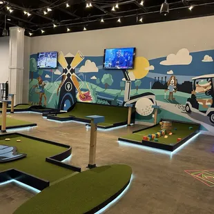 a mini golf course with a golf ball on the green