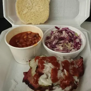 Plenty of onion &amp; pickle topping on super tasty brisket sandwich.