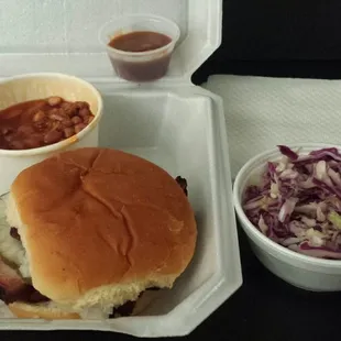 Smoked brisket sandwich, BBQ beans, cole slaw, BBQ sauce.