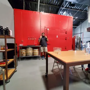 a man standing in front of a red cabinet