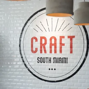 a brick wall with a sign that reads craft south miami