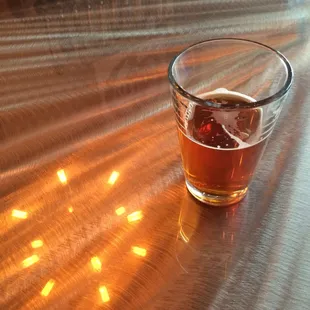 a glass of beer on a table