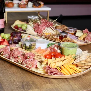 a platter of appetizers and a bottle of wine