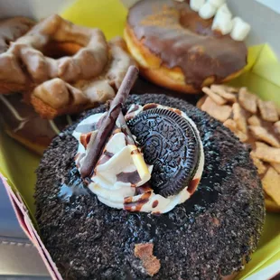 an oreo doughnut with whipped cream and chocolate