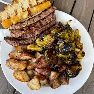 Steak plate with brussels and potatoes