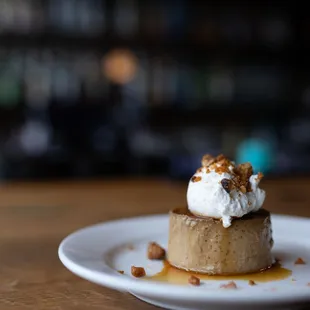 a dessert on a white plate on a wooden table