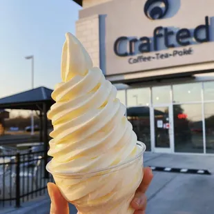 a hand holding an ice cream cone