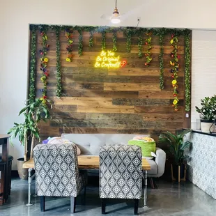 a living room with a wood accent wall